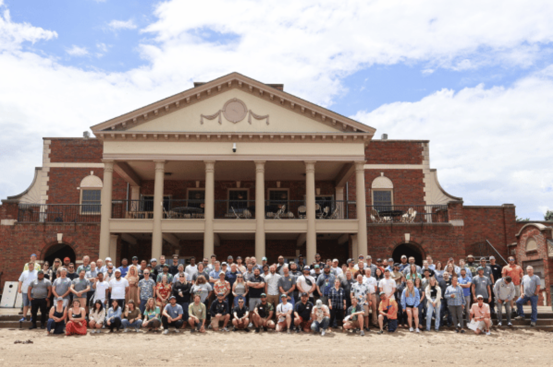 Image of large group of employees outside of building